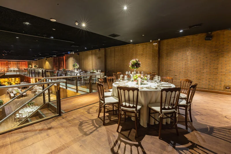 Illustrative photograph of round tables set for an evening reception.