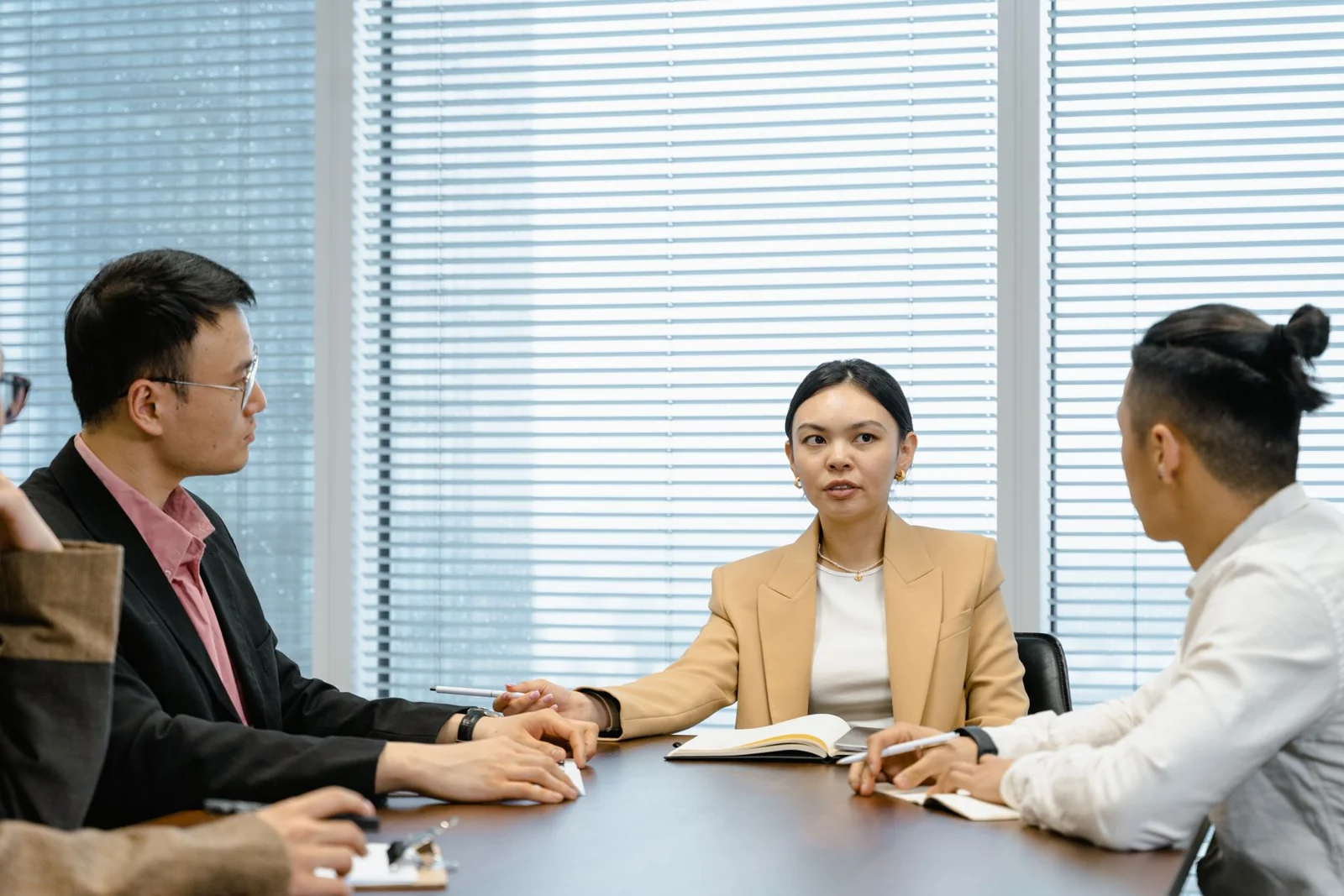 Illustrative photograph of a small group discussing a question around a table.
