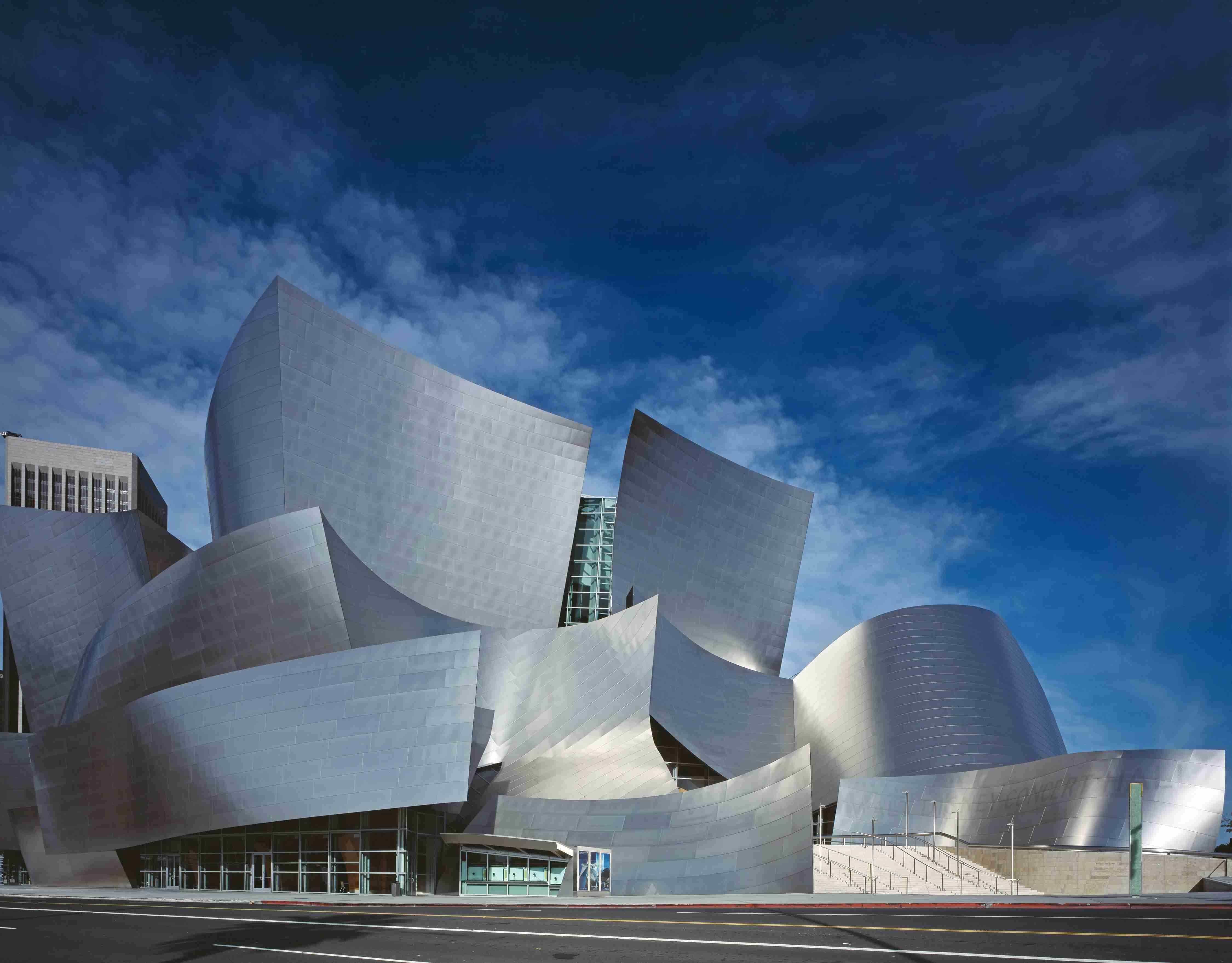 A curved metal-clad contemporary building — Real Estate