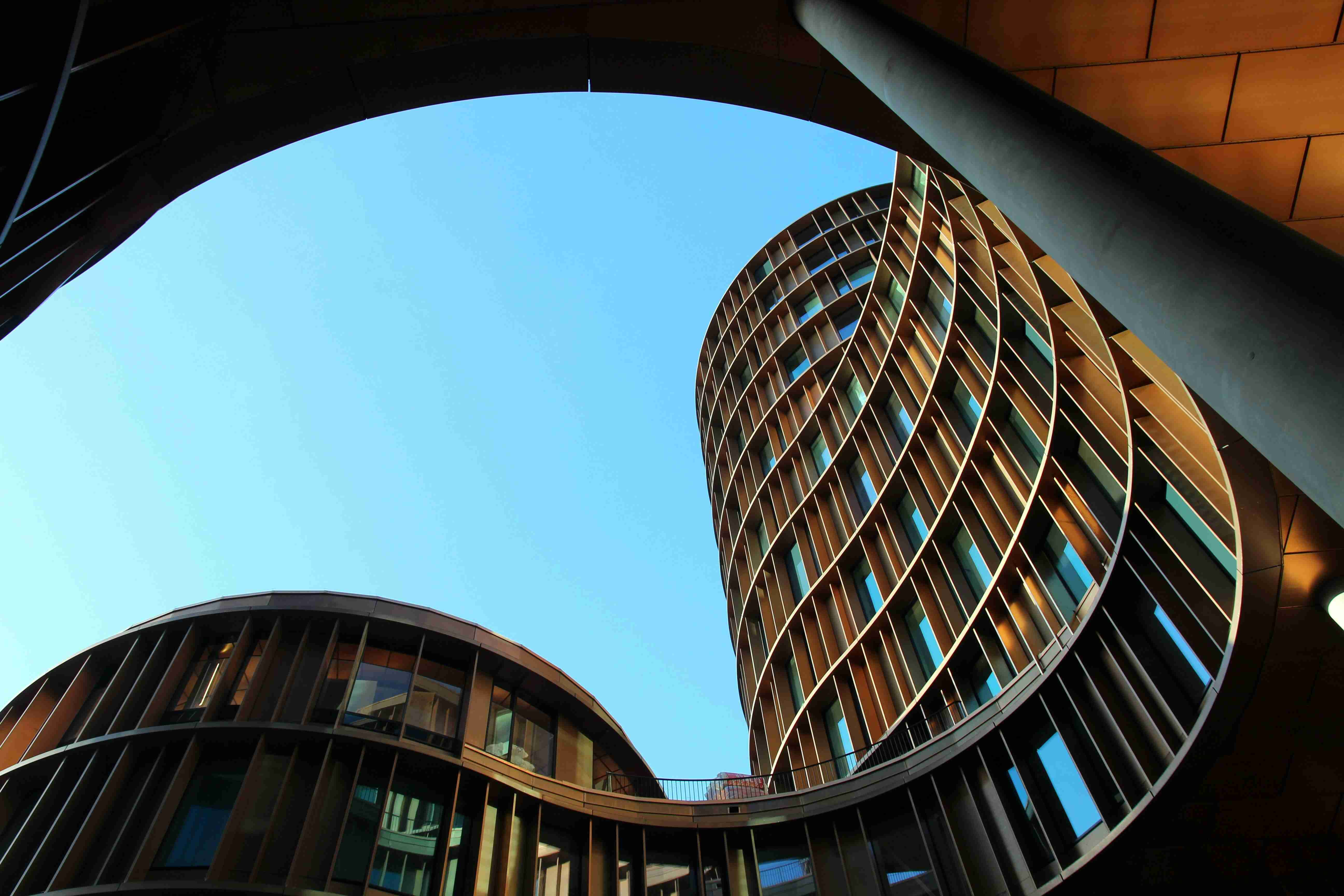 A curved contemporary building with landscaped terraces — Sustainability & Technology
