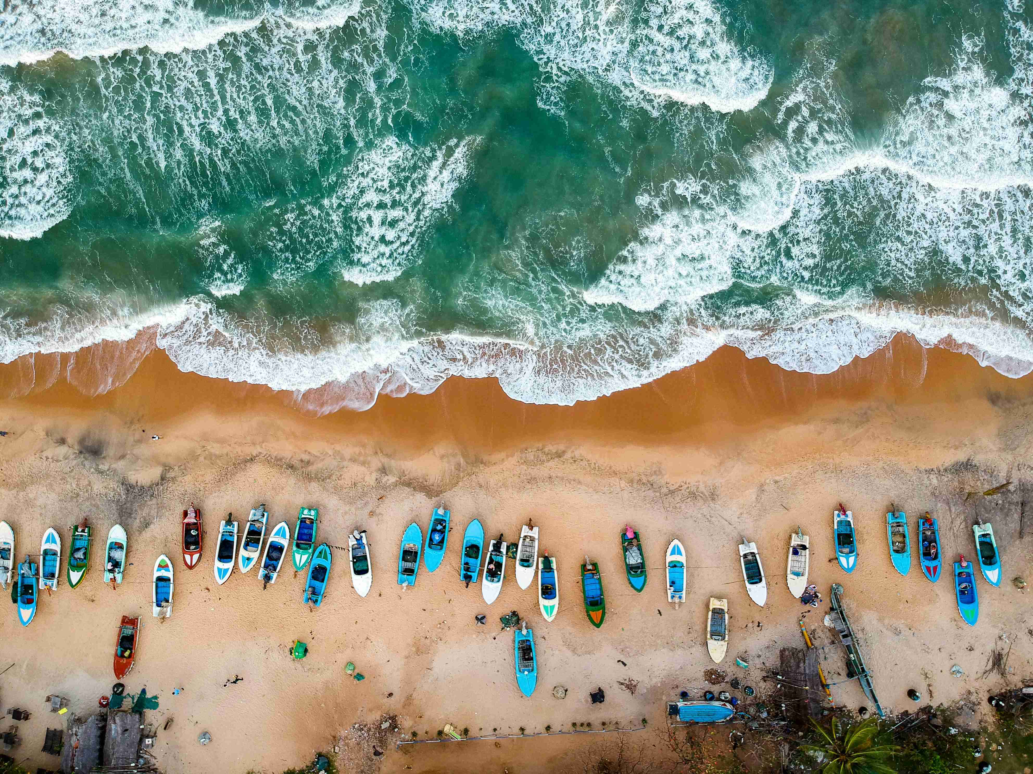 An aerial view of a beach with swimmers in the surf — Tourism