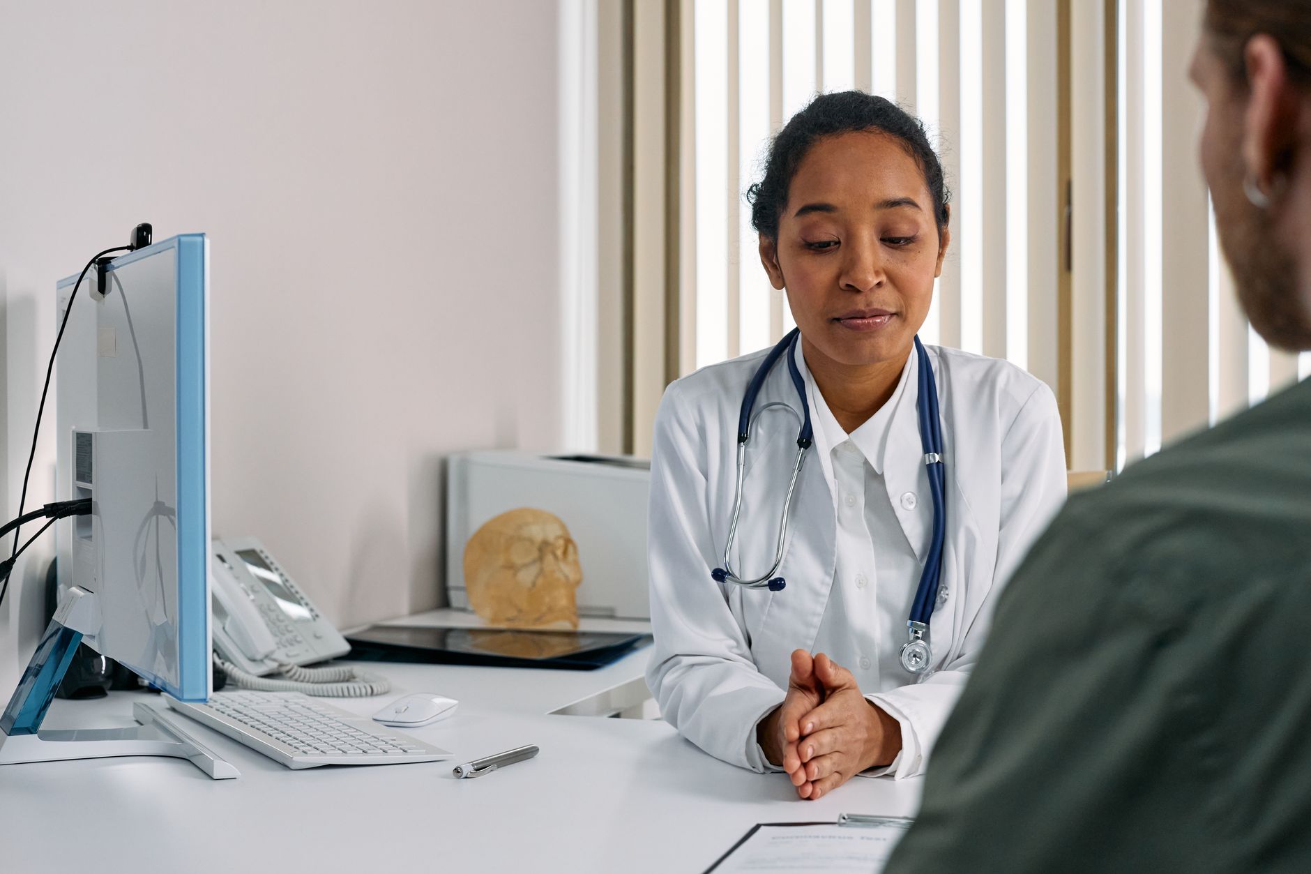 A female doctor consulting a patient in a modern medical office setting — Preventive Medicine