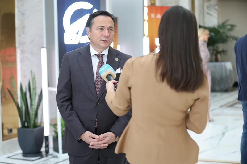 An interview beside the GIF entrance banner at GIF Georgia 2025.