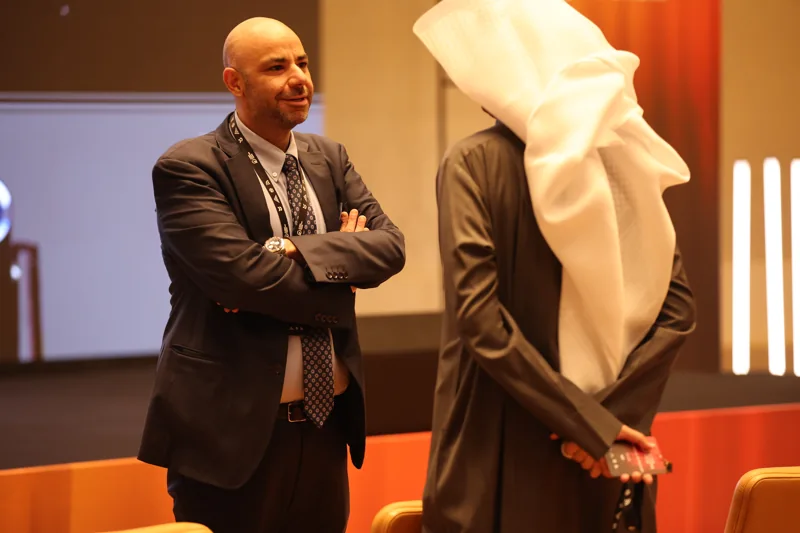 Delegates talking beside the conference seating at GIF Georgia 2025.