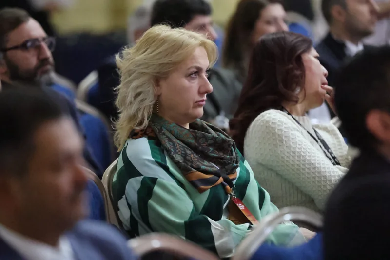 A delegate listening to a session at GIF Georgia 2025.