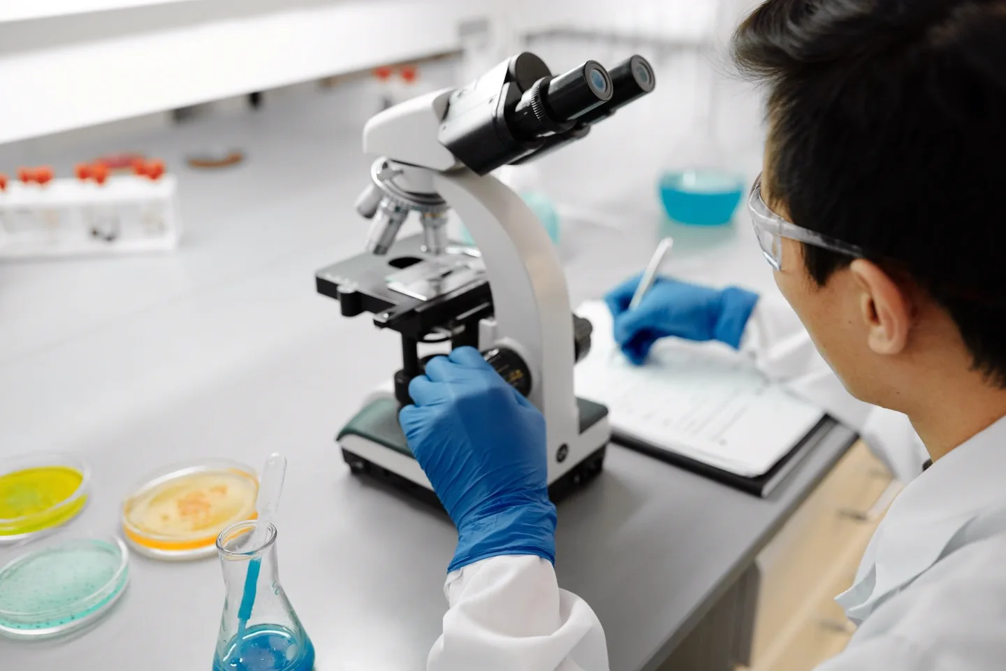 Researcher working with a microscope in a laboratory.